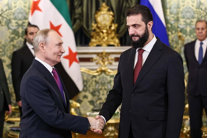 RUSSIA, MOSCOW - JANUARY 28, 2026: Vladimir Putin (L), President of Russia, and his Syrian interim counterpart Ahmed al-Sharaa shake hands during a meeting at the Moscow Kremlin