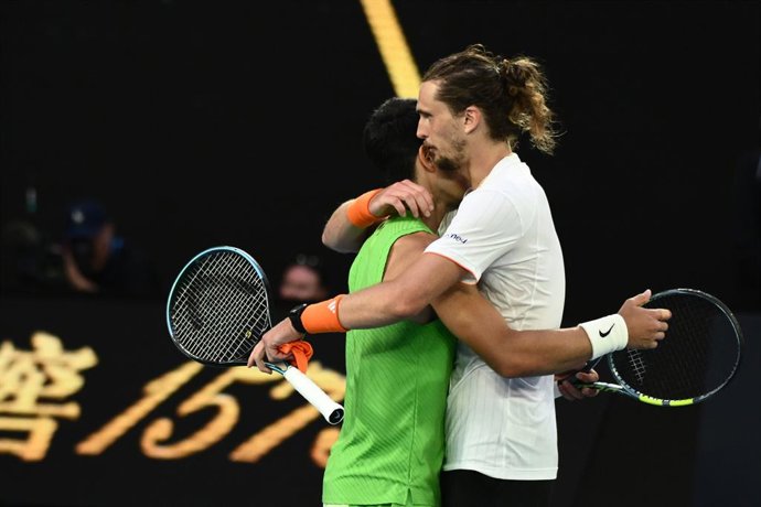 30 January 2026, Australia, Melbourne: Spanish tennis player Carlos Alcaraz embraces Germany's Alexander Zverev after the men's singles semifinal match against on day 13 of the Australian Open tennis tournament at Melbourne Park. Photo: Joel Carrett/AAP/d