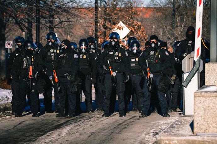 January 30, 2026, Minneapolis, Minnesota, USA: Federal agents stand guard with riot gear as activists and faith leaders rally against federal agents with the Immigration and Customs Enforcement (ICE) agency as they continue their immigration crackdown in 