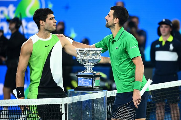 01 February 2026, Australia, Melbourne: Carlos Alcaraz of Spain and Novak Djokovic of Serbia pose for photographs at the net during the men's singles final against Novak Djokovic of Serbia on day 15 of the 2026 Australian Open tennis tournament at Melbour