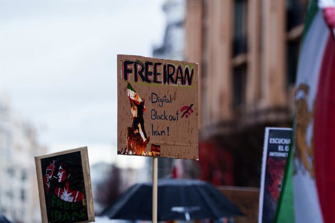 Manifestante carrega cartaz com o slogan “Free Iran. Digital blackout Iran” durante a manifestação contra a repressão no Irã, em 17 de janeiro de 2026, em Madri (Espanha). A marcha foi convocada para mostrar repúdio à repressão sofrida pela população.