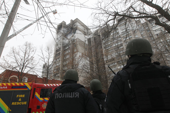 January 22, 2026, Dnipro, Ukraine: A rescuer extinguishes a fire from a ladder truck at a 16-storey residential building hit by a Russian drone in Dnipro, Ukraine, on January 22, 2026