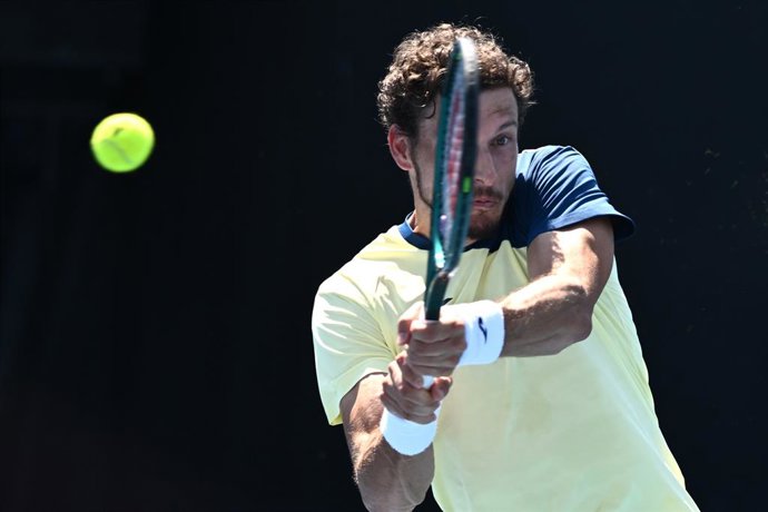20 January 2026, Australia, Melbourne: Spanish tennis player Pablo Carreno Busta plays a f backhand return against Czech Republic's Jakub Mensik during their Men's First-round tennis match on Day Three of the 2026 Australian Open tennis tournament at Melb