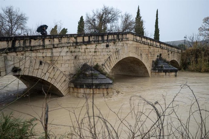 Agentes de la policía Local de Puente Tablas (Jaén) vigila la crecida del río Guadalbullón a su paso por la localidad. 
