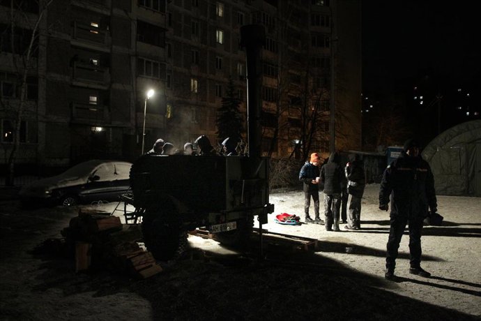January 25, 2026, Kyiv, Ukraine: Rescuers stand by a makeshift stove as they are on duty near mobile heating tents set up in Kyivâ€s northern left-bank Desnianskyi district to counter power and heating outages caused by Russian strikes on Ukraineâ€s energ