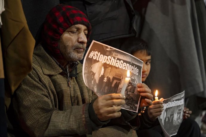 February 6, 2026, Srinagar, Jammu And Kashmir, India: A Shia Muslim man holds a candle and a poster reading 'Stop Shia Genocide' during a protest denouncing the suicide attack on a mosque that killed 31 people. Shia Muslims in Srinagar staged protests ove