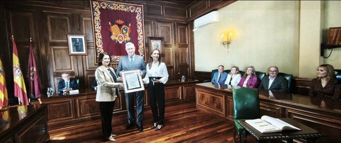 La alcaldesa de Teruel, Emma Buj, entrega el reconocimiento por los 25 años de Dinópolis a su presidente, Manuel Blasco, y a la la directora-gerente del parque, Higinia Navarro, en presencia de la corporación municipal.