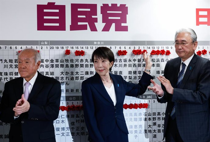BEIJING, Feb. 9, 2026  -- Japanese Prime Minister Sanae Takaichi (C), leader of Japan's ruling Liberal Democratic Party (LDP), places red flowers symbolizing success onto names of candidates at the headquarters of the LDP in Tokyo, Japan, Feb. 8, 2026. Ja