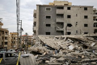 January 22, 2026, Qannarit, Qannarit, Lebanon: A electricity worker fixes cables near wreckage of a building that was destroyed in an Israeli air raid in the southern Lebanese village of Qannarit. Israel has continued to launch regular strikes in south Le