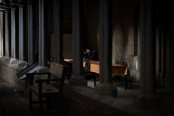 Archivo - Una persona sin techo come en las instalaciones de la parroquia de Santa Anna, en Barcelona, en una imagen de archivo