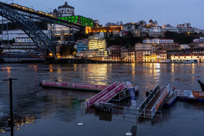 February 6, 2026, Porto, Portugal: High tide floods seen at the Douro riverfront beneath the Dom Luís I Bridge submerging sightseeing docks and ramps as illuminated landmarks reflect across the rising water at night.