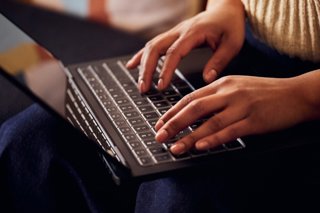 Persona usando el teclado de un portátil Windows