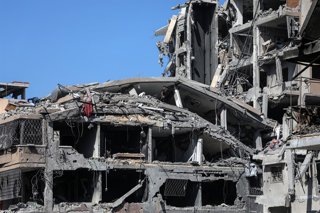 GAZA, Oct. 20, 2025  -- People are seen on destroyed buildings in Gaza City, on Oct. 19, 2025. The Israel Defense Forces (IDF) said in a statement on Sunday that it had launched a new wave of strikes against Hamas militant targets in the southern Gaza Str