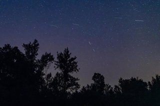Archivo - 12 August 2024, Spain, Segovia: Meteors streak past stars in the night sky during the annual Perseid meteor shower above Santo Tome del Puerto. The Perseids are an annual prolific meteor shower occurring in July and August. Photo: Guillermo Guti