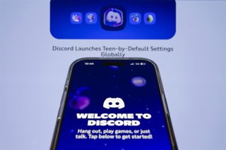February 10, 2026, Taichung, Taiwan: Discord app is displayed on iPhone backdropped by its web page. 