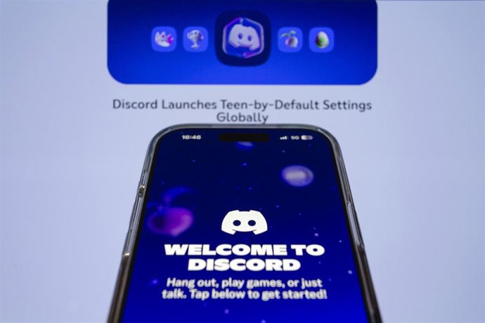 February 10, 2026, Taichung, Taiwan: Discord app is displayed on iPhone backdropped by its web page. 