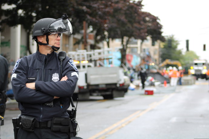 01 July 2020, US, Seattle: A police officer stands guard at an almost empty street following the Seattle's mayor Jenny Durkan order to end up all kinds of protests and demonstrations which led to the arrest at least 20 people.