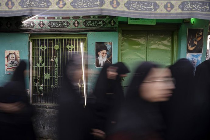 February 28, 2026, Baramullah, Jammu And Kashmir, India: Protesters walk past a photograph of Ayatollah Ali Khamenei during a protest. The office of Iranâ€s Supreme Leader and the presidential office in Tehran were reportedly targeted in coordinated milit