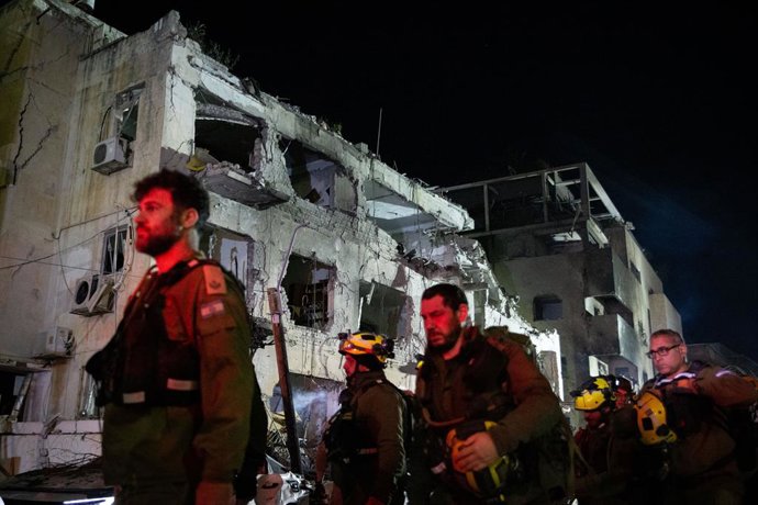 TEL AVIV, March 1, 2026  -- Members of the Israeli security and rescue forces work at the scene where a ballistic missile fired from Iran hit and caused damage in Tel Aviv, Israel, early on March 1, 2026.   The United States and Israel on Saturday launche