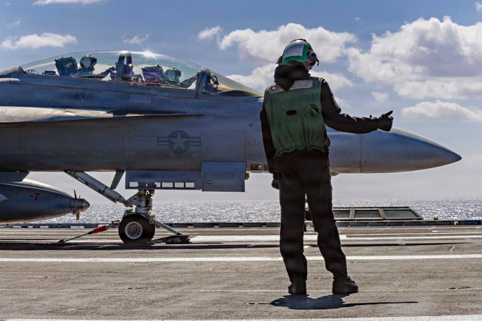 February 28, 2026, USS Gerald R Ford, International Waters: A U.S. Navy sailor signals for launch of a F/A-18F Super Hornet aircraft, attached to the Blacklions of Strike Fighter Squadron 213, from the flight deck of the Ford-class aircraft carrier USS Ge