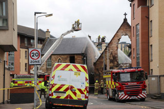 28 July 2021, United Kingdom, Glasgow: Firefighters operate at the scene of a fire at St Simon's Church. Photo: Daniel Harkins/PA Wire/dpa