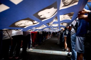 Archivo - March 24, 2025, Buenos Aires, Argentina: Protesters display a banner with portraits of missing people, victims of Argentina's last military dictatorship during the demonstration to commemorate the 49th anniversary of the 1976 military coup.