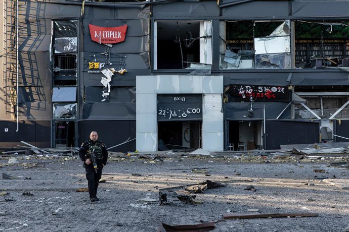 March 22, 2022, Kyiv, Ukraine: Ukrainian soldier seen patrolling with his rifle at a bomb site during military curfew. Amid Russia's offensive on the capital city of Ukraine, the Retroville mall in Podilskyi district, Kiyv, Ukraine was bombed by a Russian