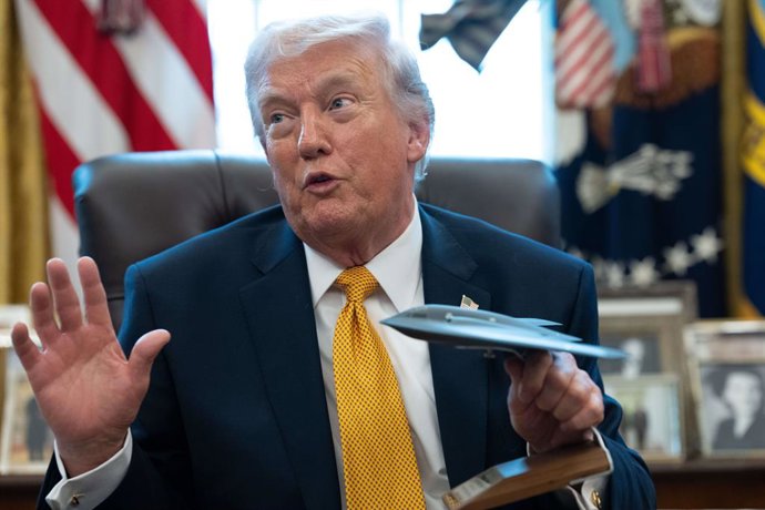 March 16, 2026, Washington, District Of Columbia, USA: United States President Donald J Trump holds a model stealth bomber as he during an Executive Order signing event in the Oval Office of the White House in Washington, DC, USA, on Monday, March 16, 202