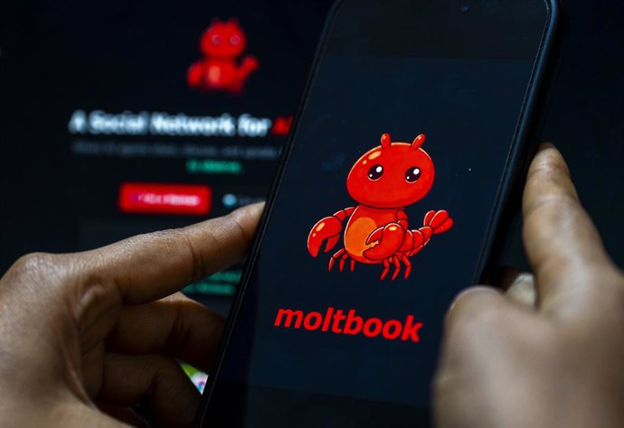 March 13, 2026: In this photo illustration, a smartphone displays the logo of the social networking platform "Moltbook" on its screen  with the appâ€s website visible in the background, in New Delhi, India on 13 March 2026. Meta has acquired Moltbook, a v