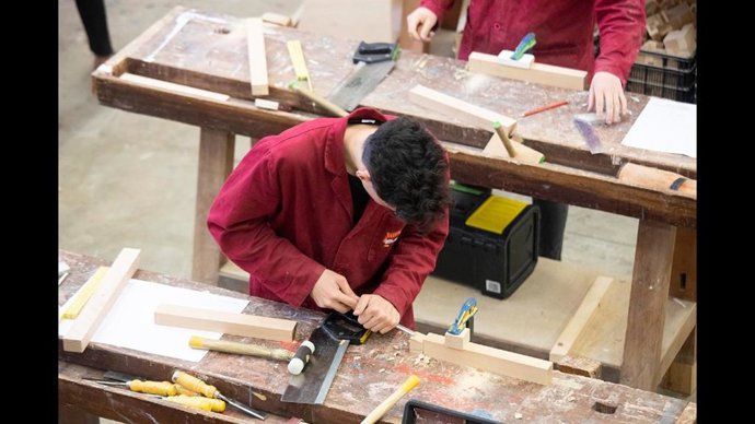 Persona en un grado de Carpintería en una foto de archivo.