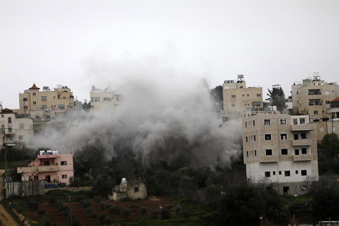 March 14, 2026, Hebron, West Bank, Palestinian Territory: Smoke and dust rise as the Israeli military destroys the home of Palestinian prisoner Azmi Abu Hlayel, who is said to be responsible for the 2024 attack on Israelis, in his home village of Dura, we