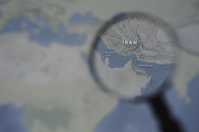 March 13, 2026, Taichung, Taiwan: A magnified image of a map through a handheld magnifying glass depicts the Persian Gulf, Iran, the Strait of Hormuz and the Gulf of Oman.