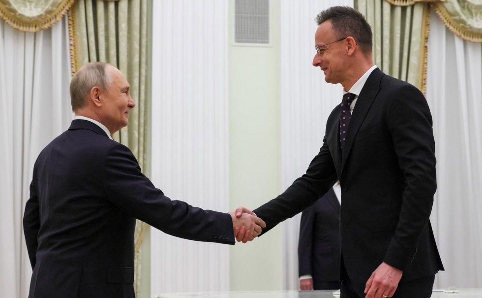 HANDOUT - 04 March 2026, Russia, Moscow: Russian President Vladimir Putin (L) shakes hands with Hungarian Foreign Minister Peter Szijjarto prior to their meeting at the Kremlin.