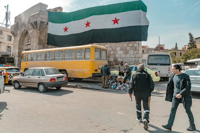 Archivo - Arquivo - 4 de março de 2025, Damasco, Síria: Uma bandeira síria é vista na entrada da cidade velha. Os muçulmanos na Síria estão celebrando seu primeiro Ramadã desde a queda do regime de Bashar al-Assad, em dezembro de 2024.