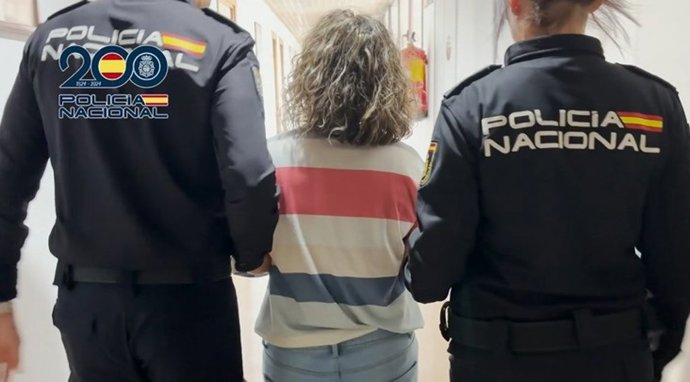 Agentes de la Policía Nacional junto a la acusada por tenecia de pornografía infantil