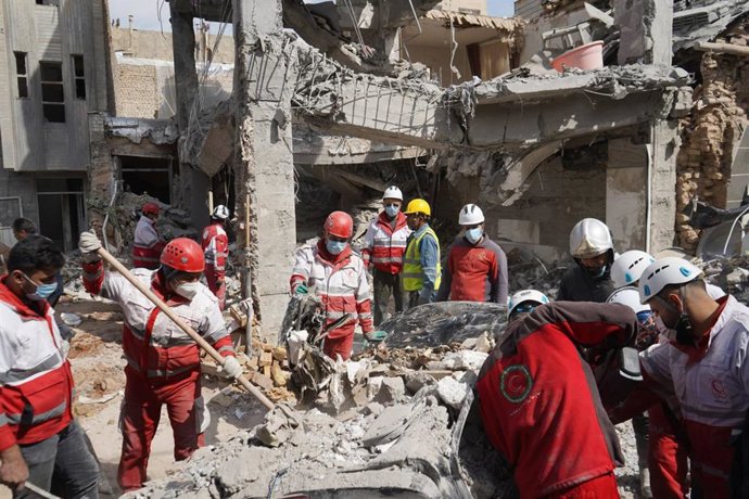 March 25, 2026, Iran, Iran: Rescue teams from the Iranian Red Crescent Society (IRCS) are working at the site of a building destroyed by an airstrike. Iran said it fired cruise missiles at the USS Abraham Lincoln aircraft carrier, according to a statement