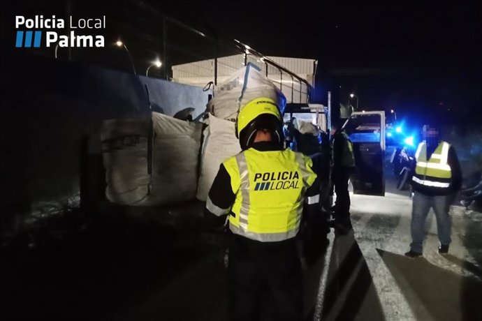 Un agente de la Policía Local de Palma inmoviliza uno de los camiones.