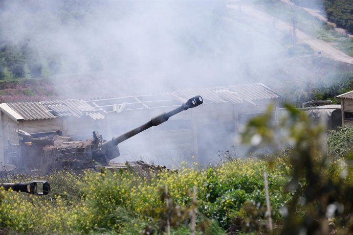 JERUSALEM, March 27, 2026  -- An Israeli artillery fires shells into southern Lebanon as seen from northern Israeli border with Lebanon, March 27, 2026.