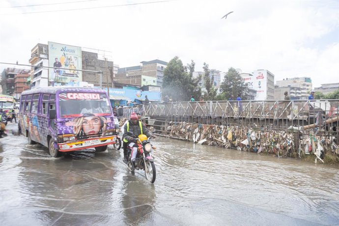 March 9, 2026, Nairobi, Kenya: A motorcycle rider and a public minibus drive through floodwater along Grogan Road near the Nairobi River after flooding disrupted businesses in the area. Heavy rains that pounded Nairobi, Kenya, on Friday, March 6, 2026, tr