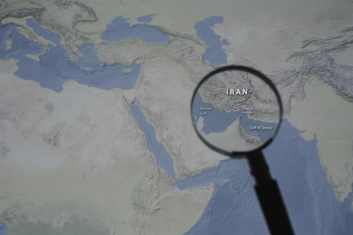March 13, 2026, Taichung, Taiwan: A magnified image of a map through a handheld magnifying glass depicts the Persian Gulf, Iran, the Strait of Hormuz and the Gulf of Oman.