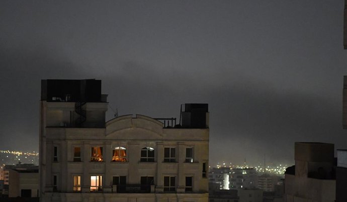 TEHRAN, March 23, 2026  -- Smoke billows following explosions in Tehran, Iran, March 23, 2026.   Loud explosions were heard in Tehran on Monday morning, a Xinhua reporter said, observing multiple flashes of light in the night sky over the eastern part of 