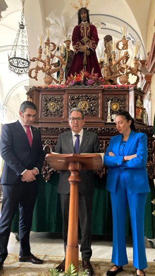 Antonio Pulido (centro), con responsables de la hermandad, ante el paso de Jesús Preso de Castro del Río.