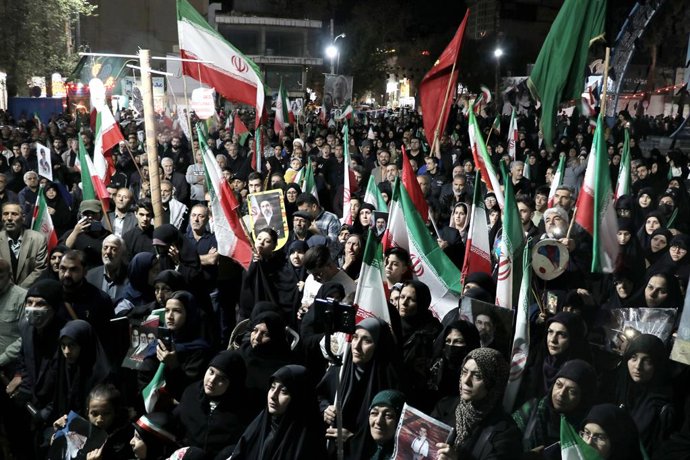 March 24, 2026, Iran, Iran: Iranian pro-government supporters wave national flags during a rally. Iran said it fired cruise missiles at the USS Abraham Lincoln aircraft carrier, according to a statement carried by state television, amid escalating conflic