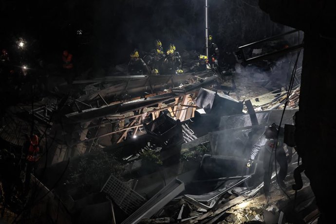 HAIFA, April 6, 2026  -- Israeli security forces and emergency responders are seen at the site of an Iranian missile attack in Haifa, northern Israel, April 5, 2026. Four people were missing and four others injured after a missile from Iran struck a resid