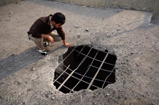 April 1, 2026, Erbil, Iraq: A Iraqi man looks at a hole on the ceiling of his home caused by a drone strike in the city of Erbil, the capital of Iraq's Kurdistan region.