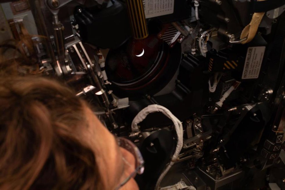 WASHINGTON, April 6, 2026 -- NASA astronaut Christina Koch looks out one of the Orion spacecraft's windows back at Earth, on April 6, 2026. The crew of the Artemis II mission on Monday broke the record for the farthest distance from Earth ever traveled b