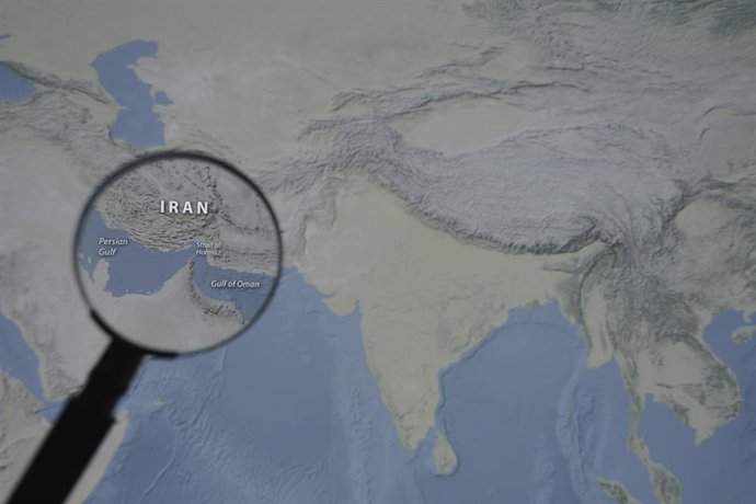 March 13, 2026, Taichung, Taiwan: A magnified image of a map through a handheld magnifying glass depicts the Persian Gulf, Iran, the Strait of Hormuz and the Gulf of Oman.