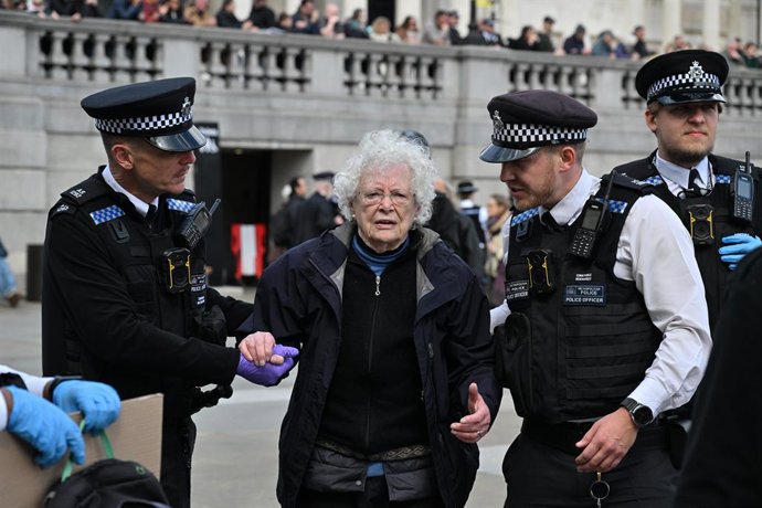 April 11, 2026, London, London, UK: London, UK. Protesters are arrested by police officers for holding up placards during a Defend Our Juries demonstration in Trafalgar Square in support of the banned Palestine Action group. Palestine Action is a British 
