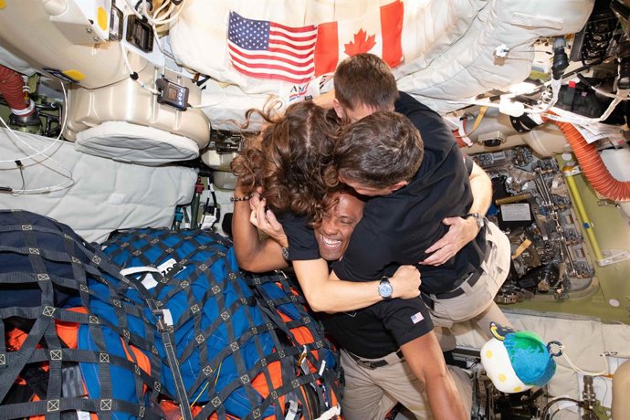 April 8, 2026, Orion Capsule, Outer Space: Artemis II crew, Mission Specialist Cristina Koch, Mission Specialist Jeremy Hansen, Commander Reid Wiseman, and Pilot Victor Glover, take time for a group hug following the successful journey around the far-side