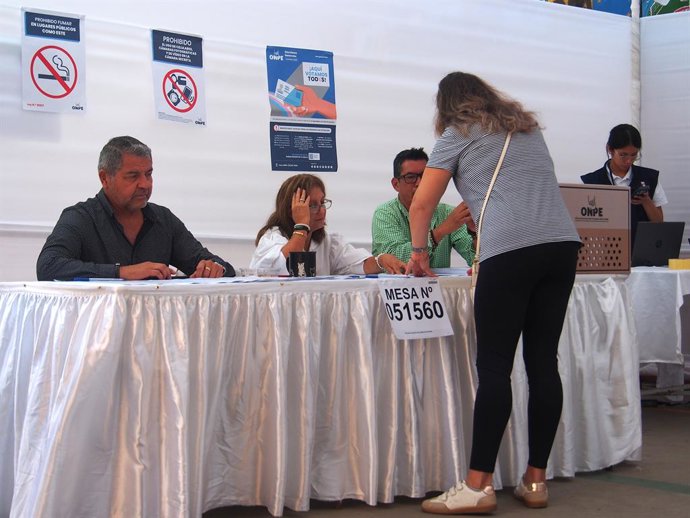 April 12, 2026, Lima, Lima, Peru: Woman casting her vote in a voting center while most Peruvian citizens queue up to cast their vote in schools, universities and sports centers throughout the country in the 2026 general elections.